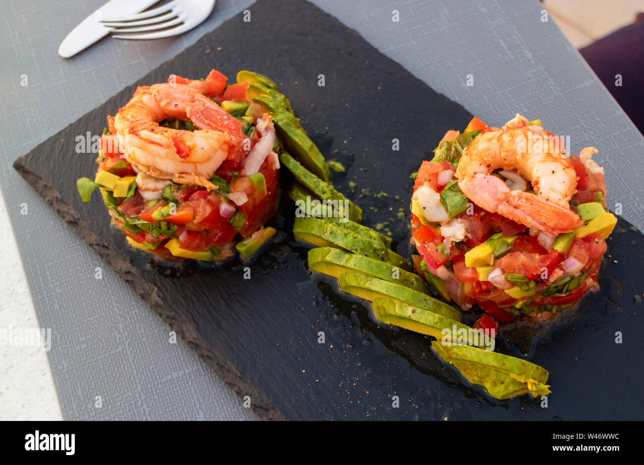 Crete, Greece. A prawn, avocado and chopped salad starter served on slate plate Stock Photo