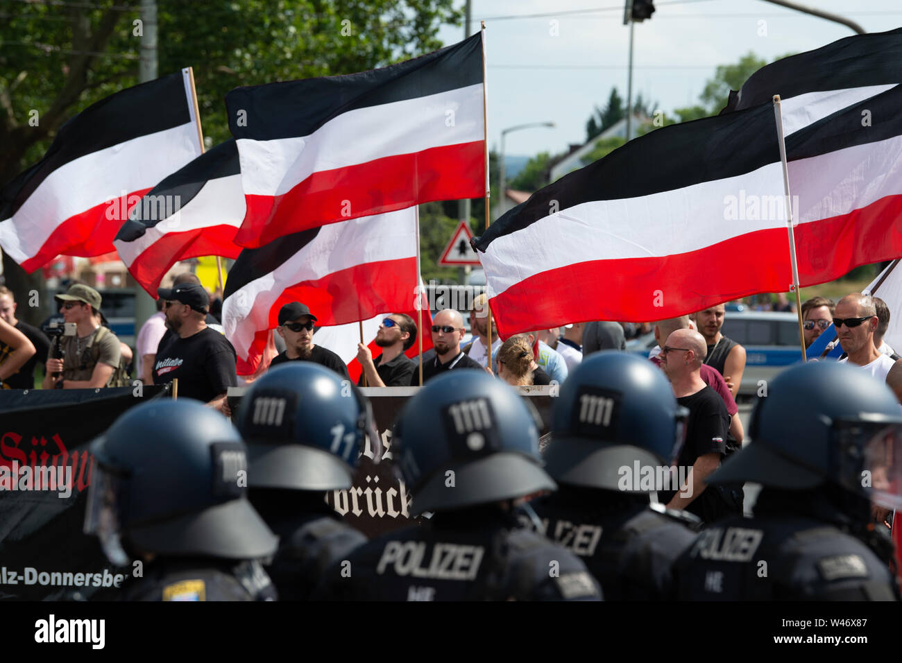 Hanover, Germany. Kassel, Germany. 20th July, 2019. Supporters of the small right-wing extremist party 'Die Rechte' (The Right) are flying their flags during the demonstration. The party had called for a demonstration in Kassel against media prejudgement in connection with the Lübcke case. A massive police presence is to prevent possible riots between the two camps. Credit: Swen Pförtner/dpa/Alamy Live News Stock Photo