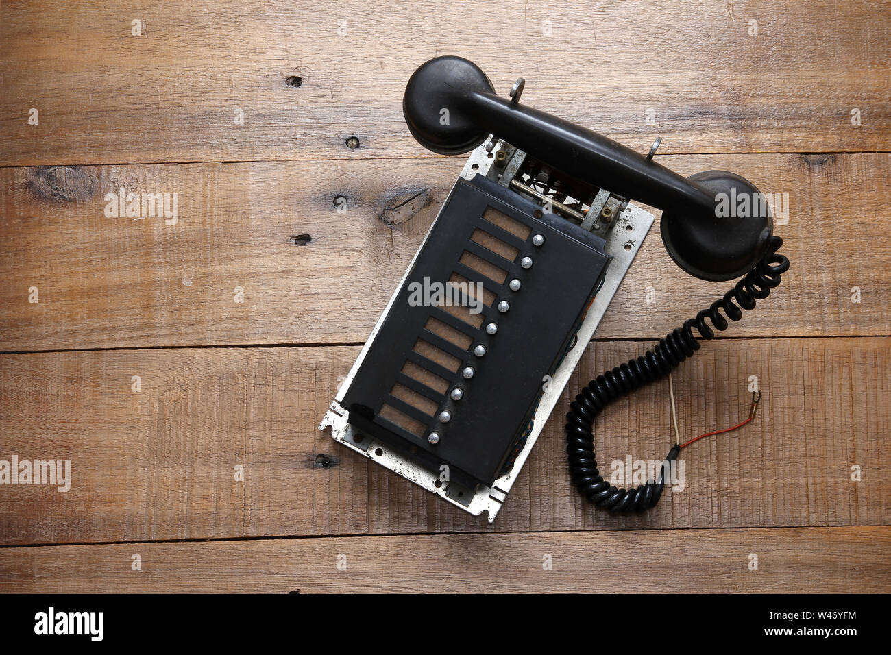 Broken Retro Phone on Wooden Background Stock Photo