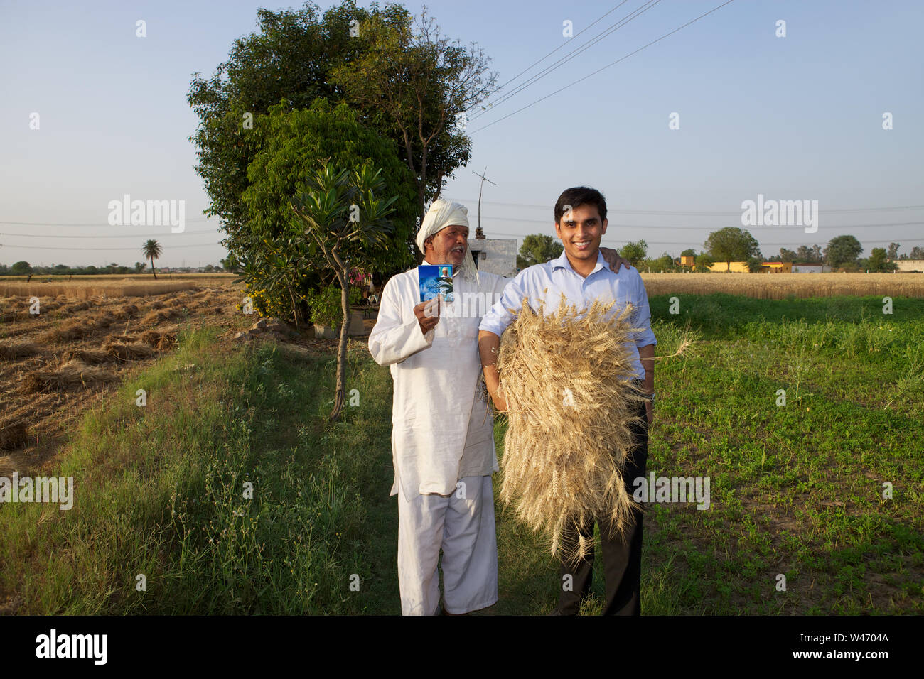 Farmer showing bank book with an executive holding harvested crop Stock ...