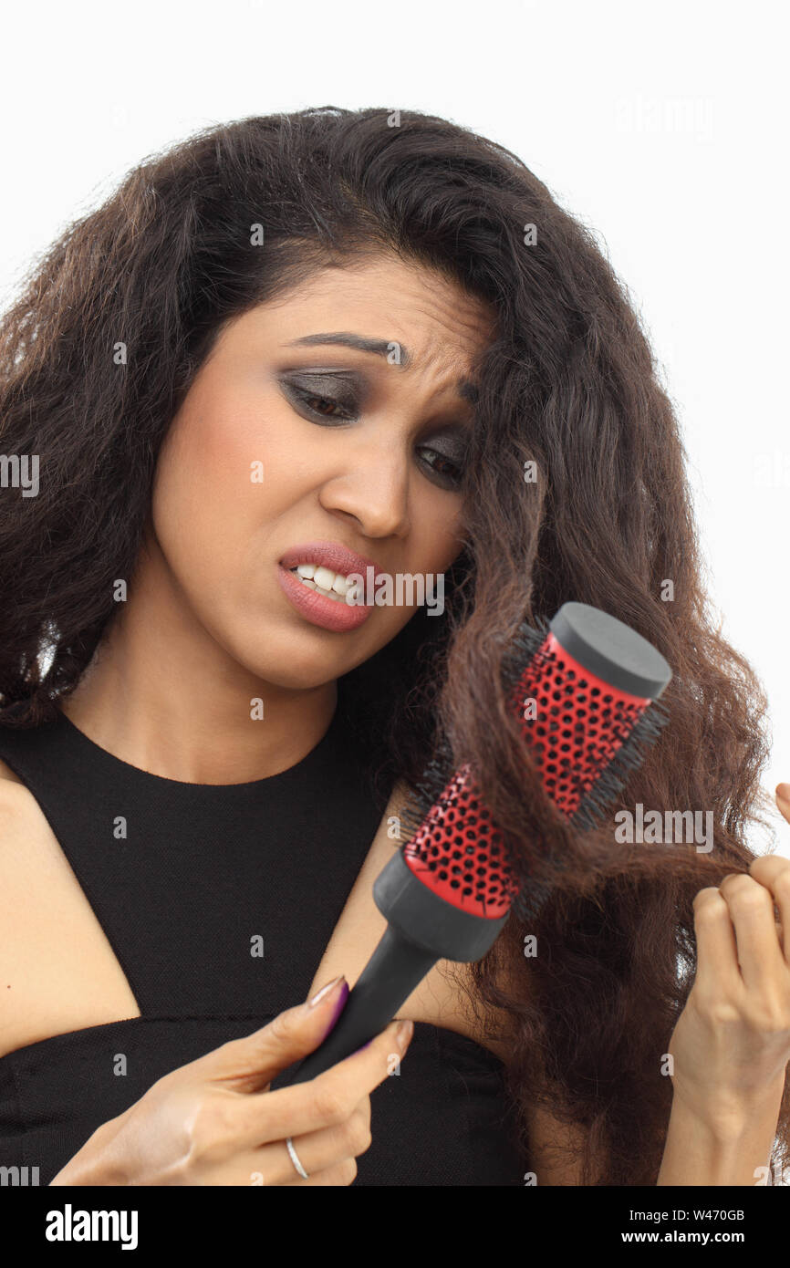 Woman brushing tangled hair Stock Photo Alamy