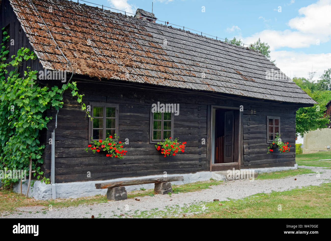 old log house, window boxes, red flowers, rural, building, Josip Broz Tito's birthplace village; Ethnological Museum Staro selo; Kumrovec; Croatia; su Stock Photo