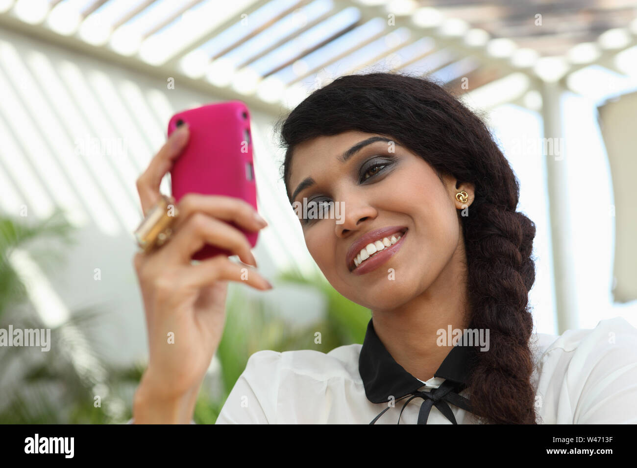 Indian young woman messaging on a mobile phone Stock Photo - Alamy