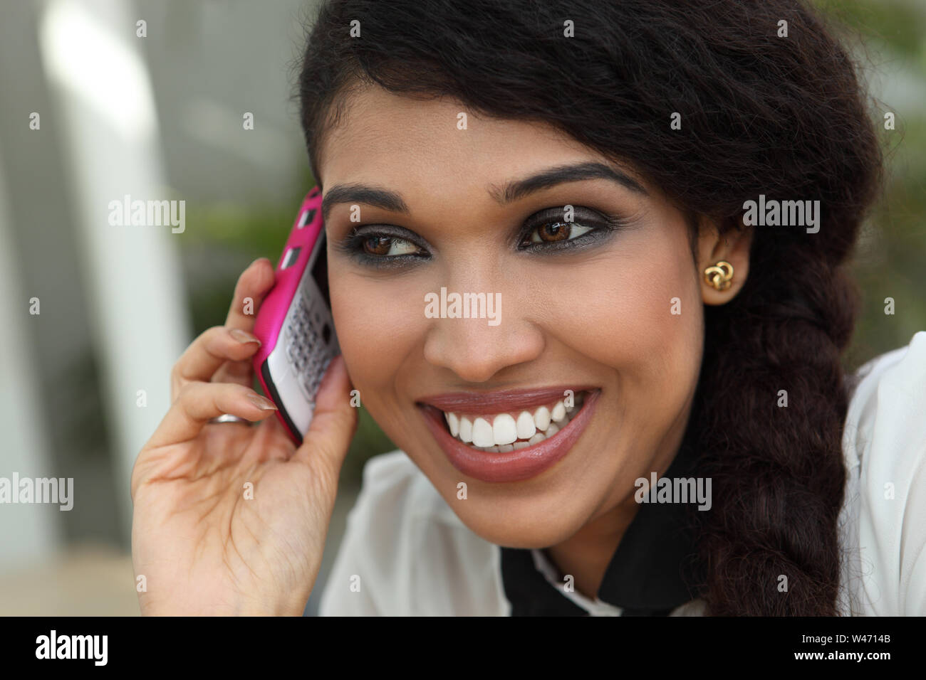 Indian young woman talking on a mobile phone Stock Photo - Alamy