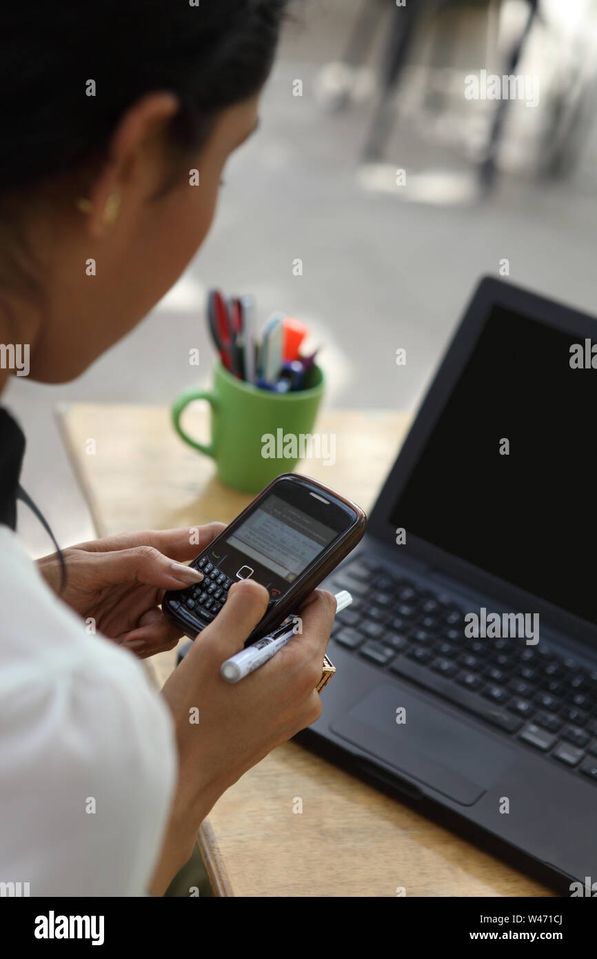 Indian young woman messaging on a mobile phone Stock Photo - Alamy