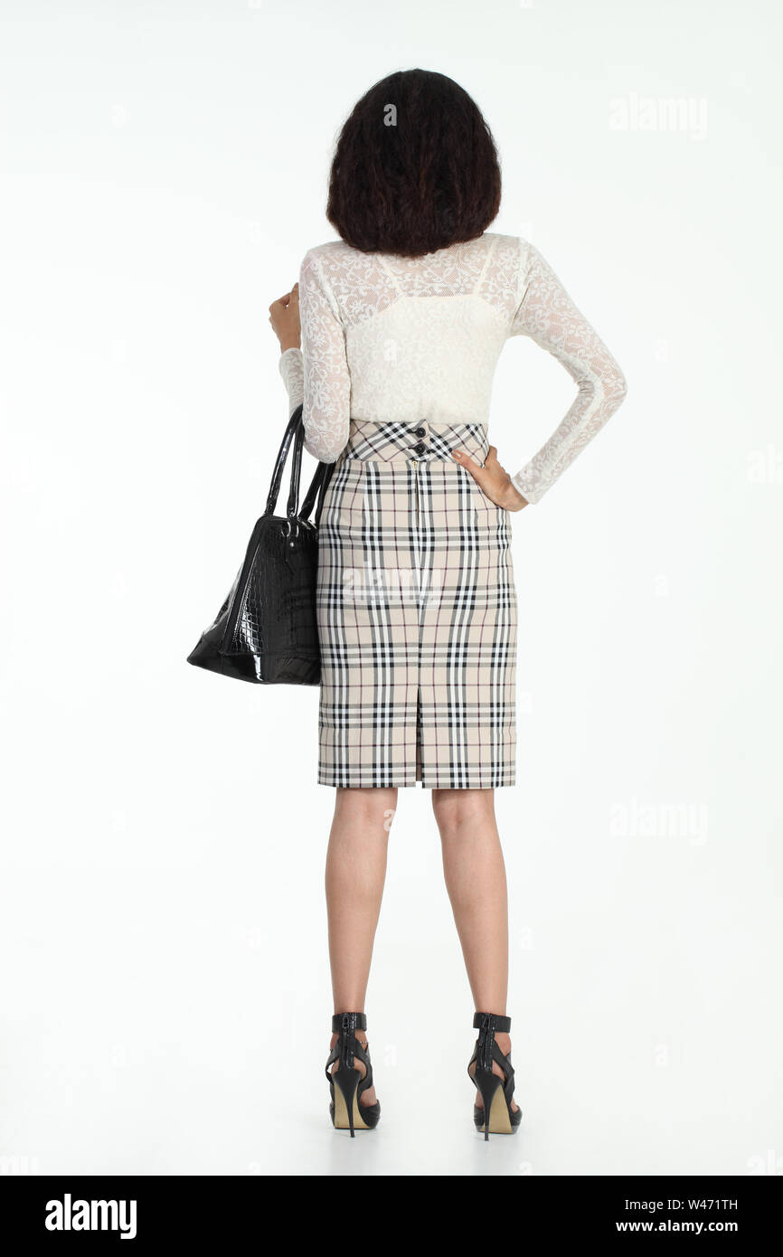 Model Rear View Stance Rear view of fashion model standing with handbag Stock Photo - Alamy