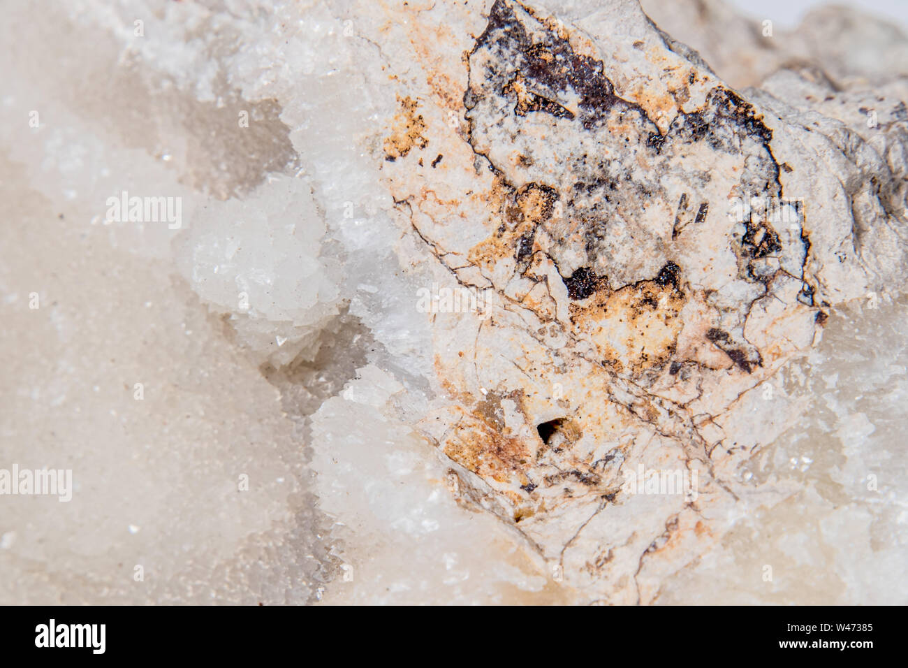 Calcsinter white gemstone formed on an usual piece of bed rock Stock Photo Alamy