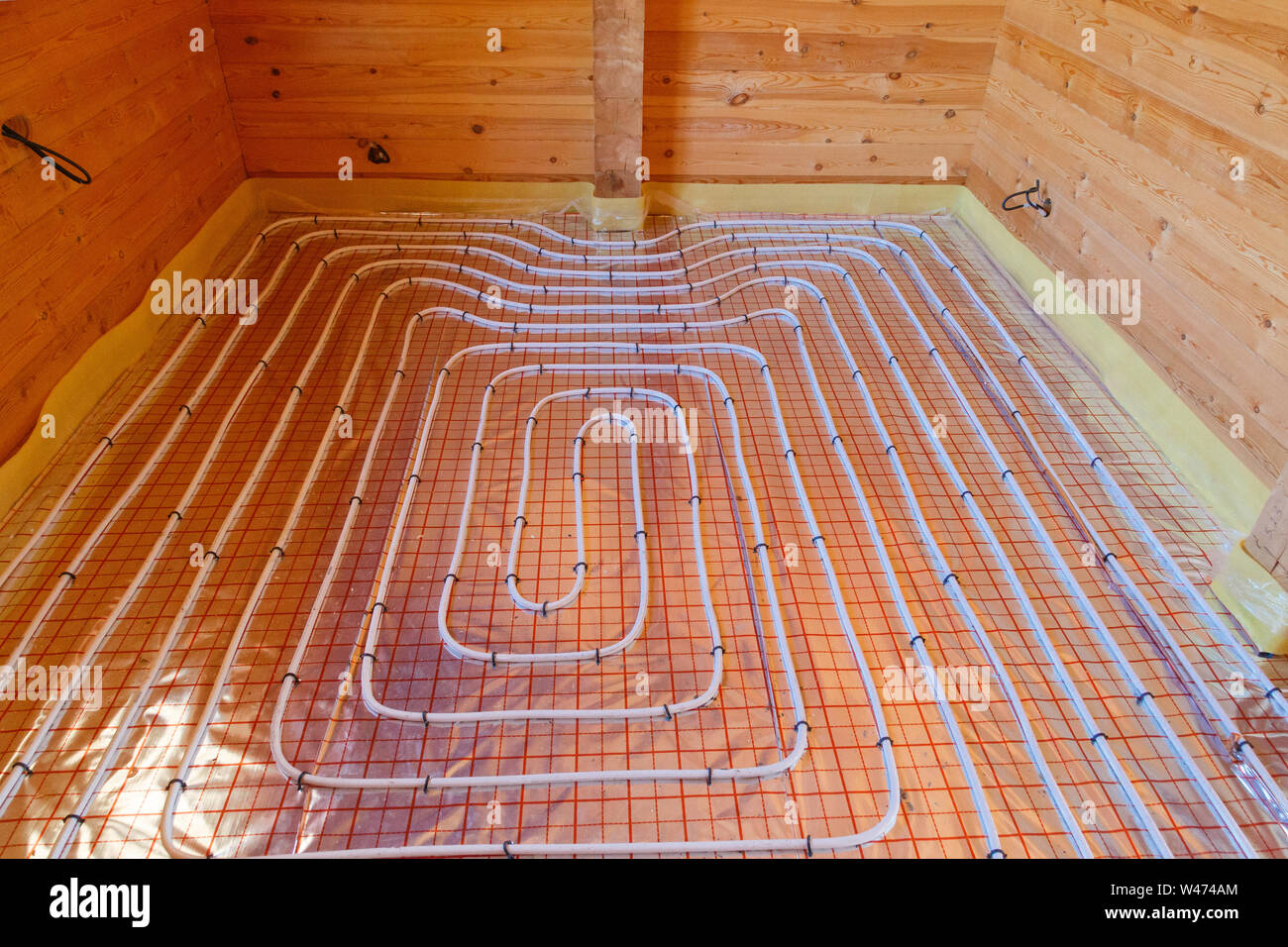 Underfloor surface heating pipes. Low temperature heating concept. Stock Photo