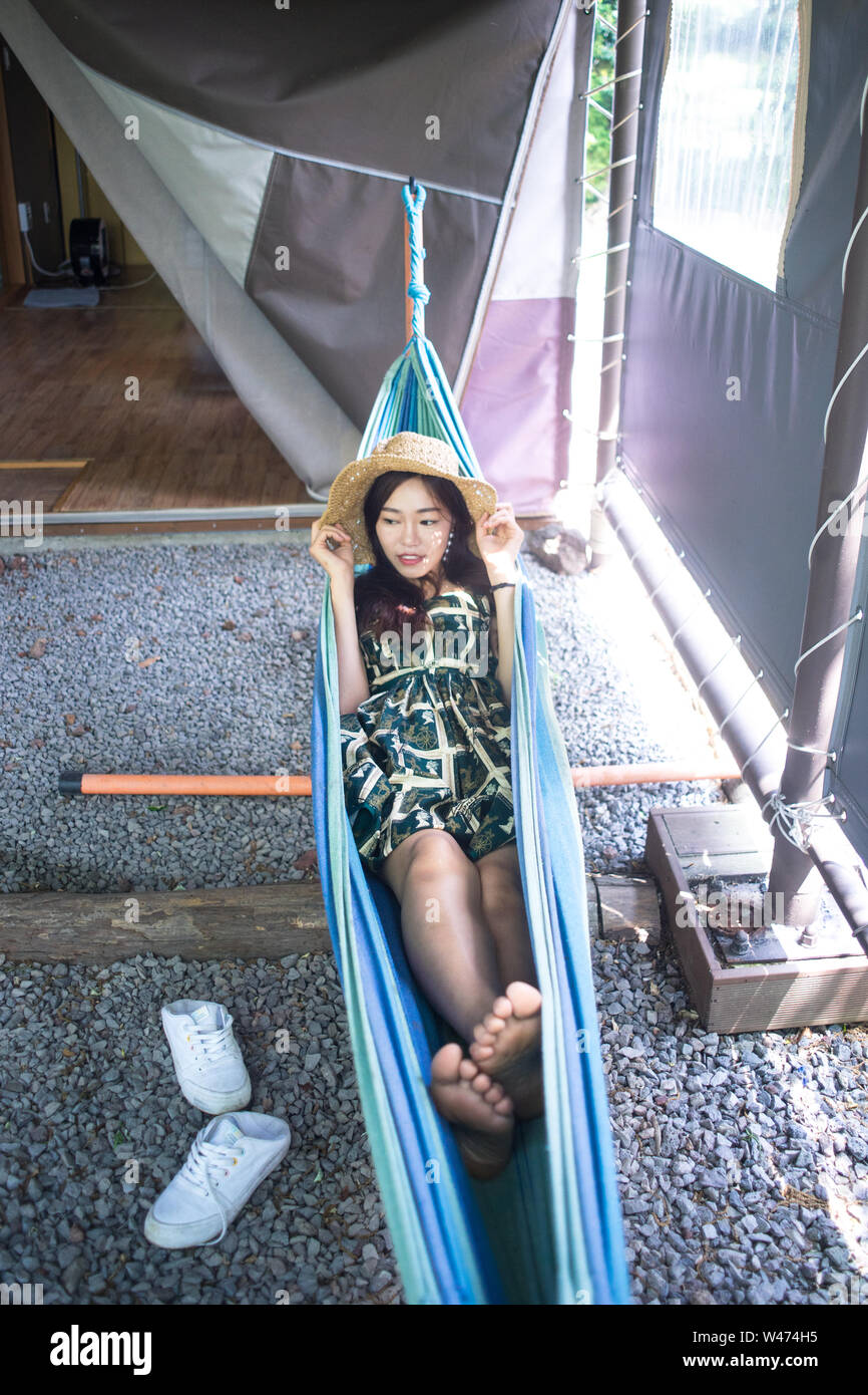 a woman lying on a hammock Stock Photo