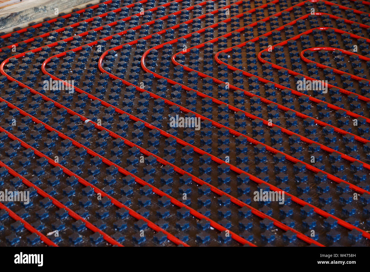 Underfloor heating installation. Close up on water floor heating system