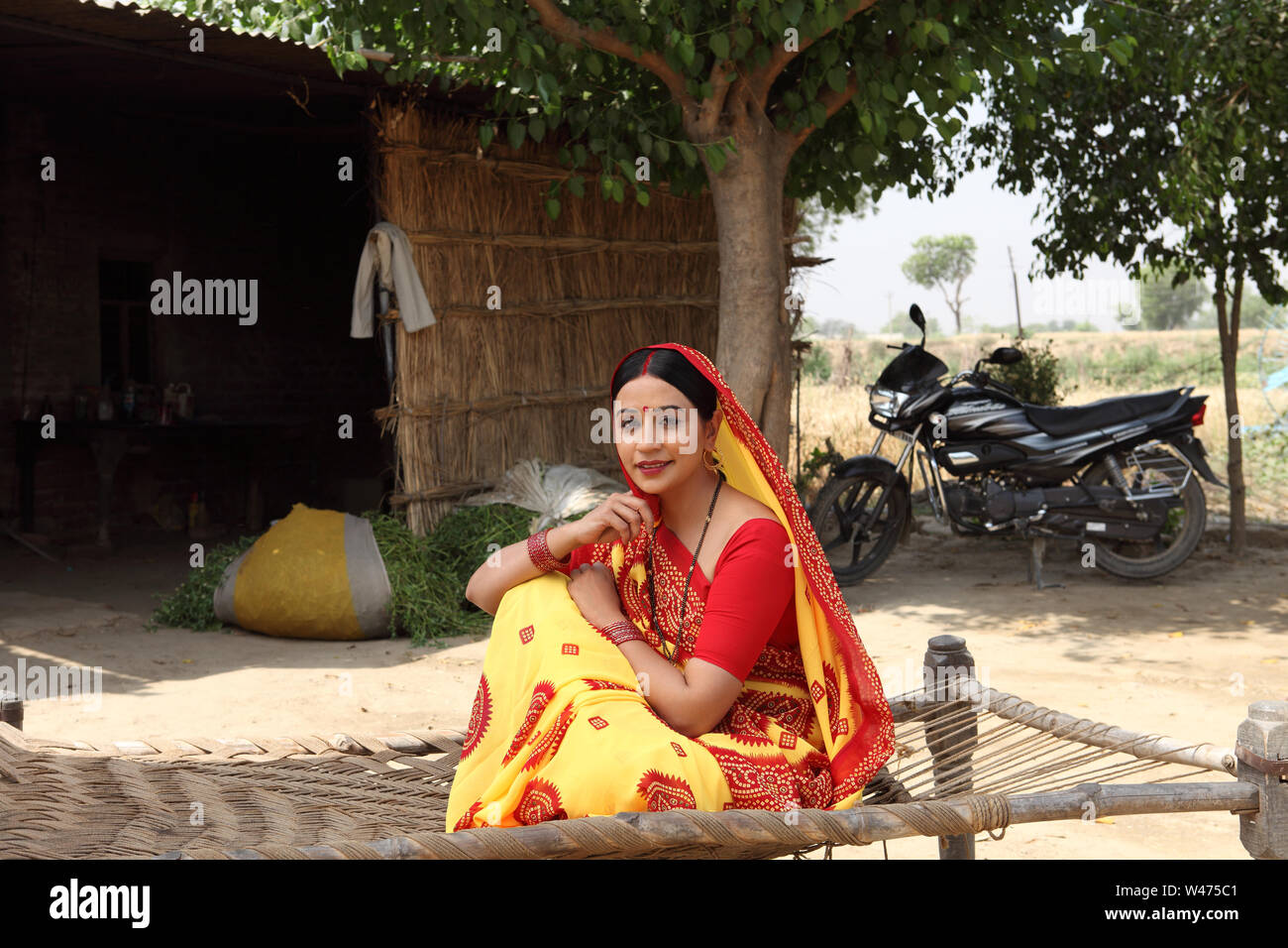 Rural woman sitting on a cot Stock Photo Alamy