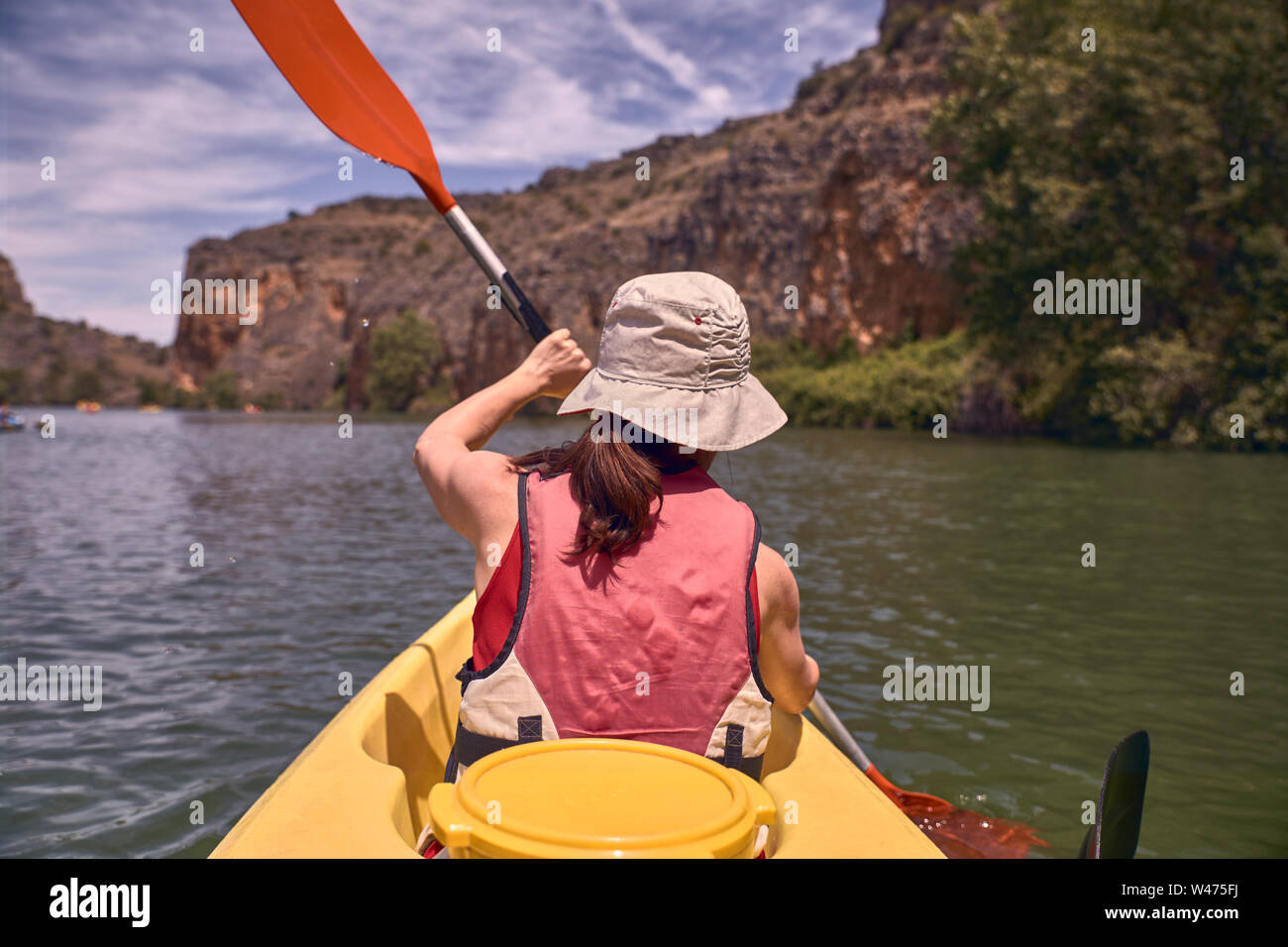Rear view of woman while kayaking in river Stock Photo