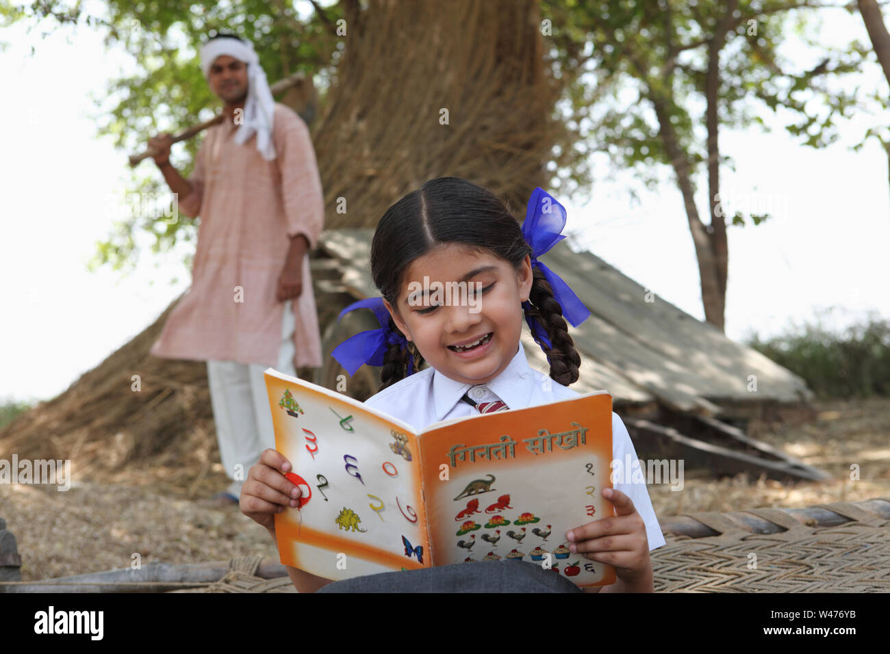 Schoolgirl reading a book Stock Photo - Alamy