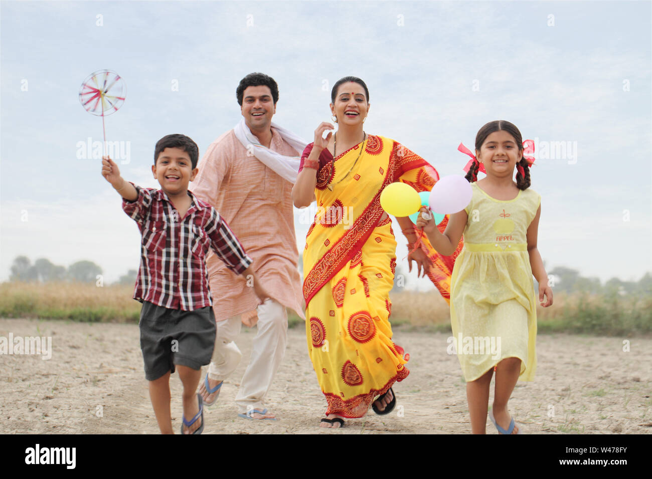 Family playing in the field Stock Photo - Alamy