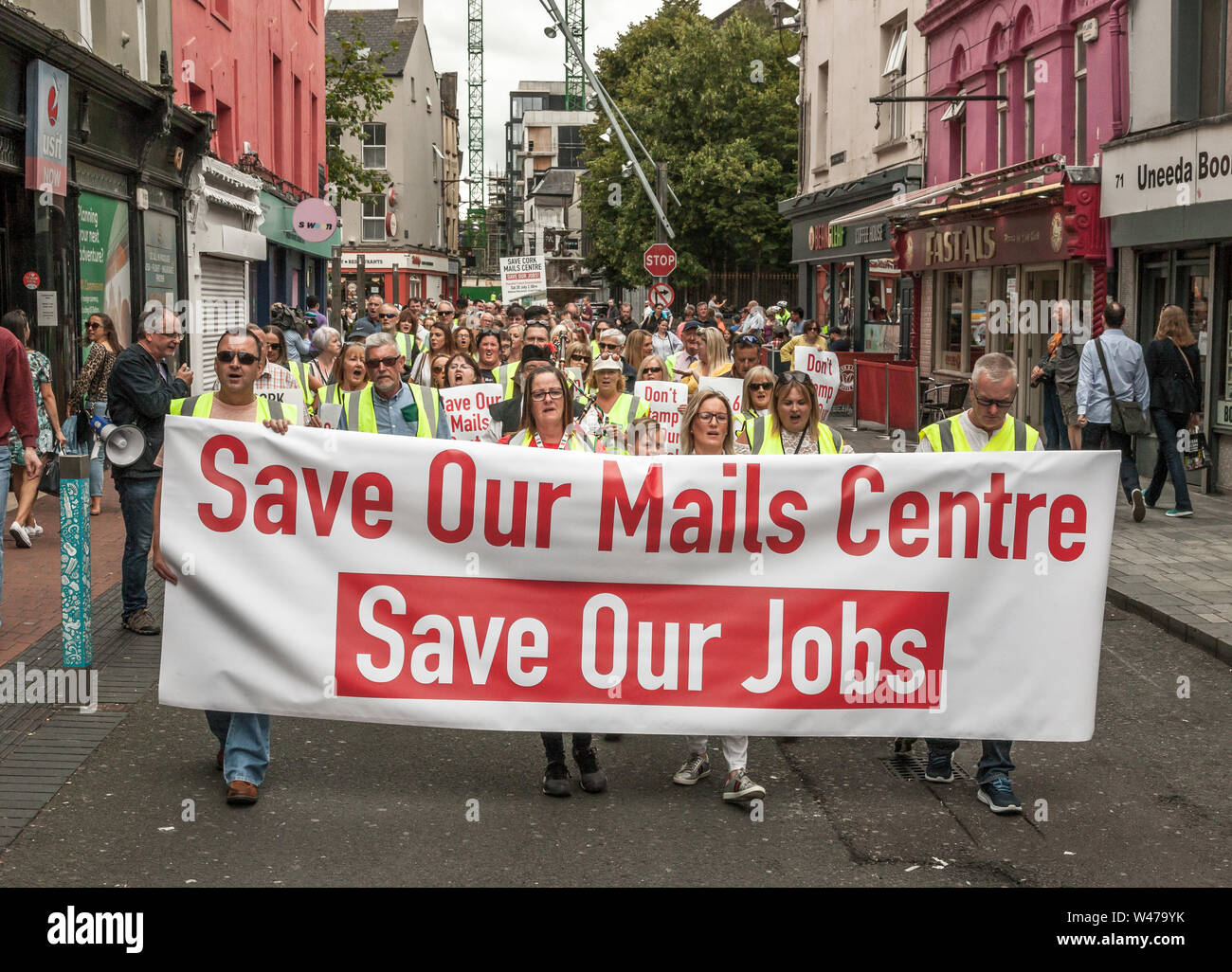 Cork City, Cork, Ireland. 20th July, 2019. Postal workers march in protest against the proposed closure by An Post of its distribution centre in Little Island with the loss of 250 jobs, on the streets of Cork, Ireland. -Credit;  David Creedon / Alamy Live News Stock Photo