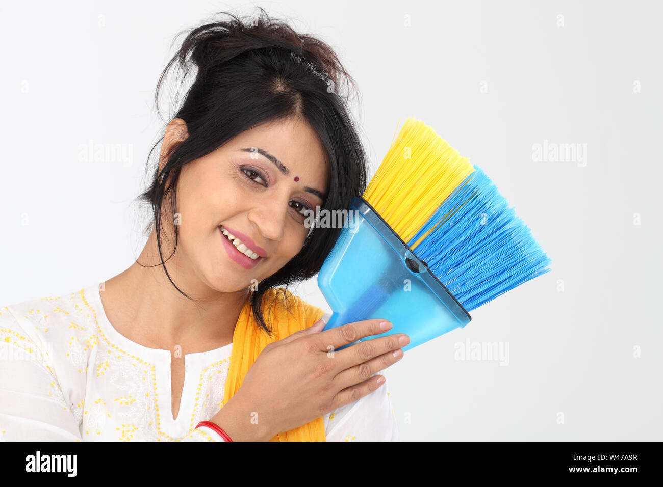 Portrait of an Indian woman holding broom Stock Photo Alamy