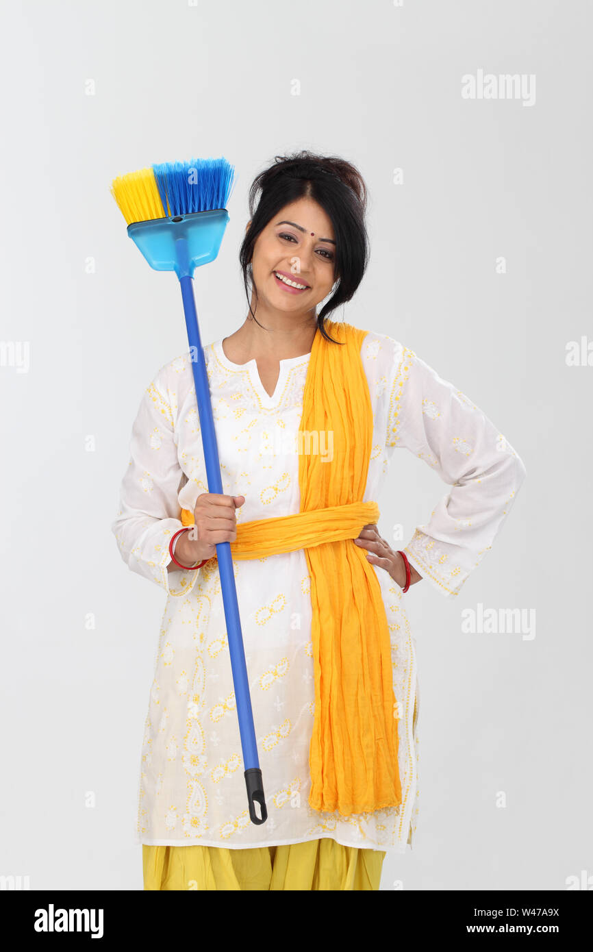 Woman holding broom and smile Stock Photo Alamy