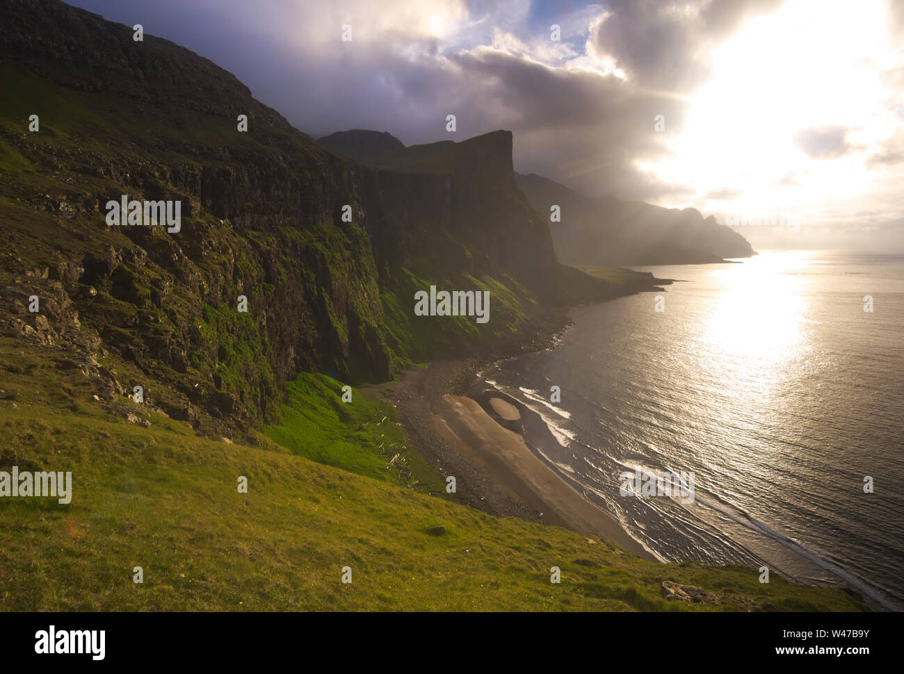 Northern coastline of Váǵar in evening light, the Faroe islands Stock Photo