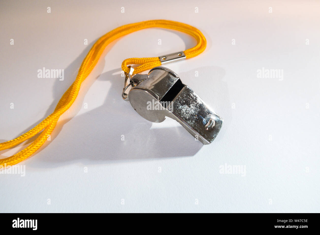Closeup of a Metal Whistle on a Yellow Lanyard, USA Stock Photo