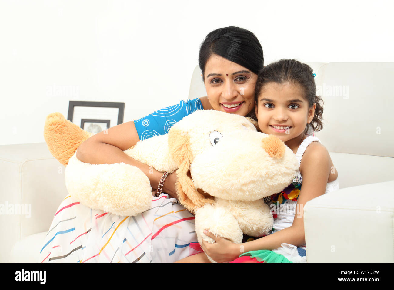 Two girls playing with a stuffed toy hi-res stock photography and ...