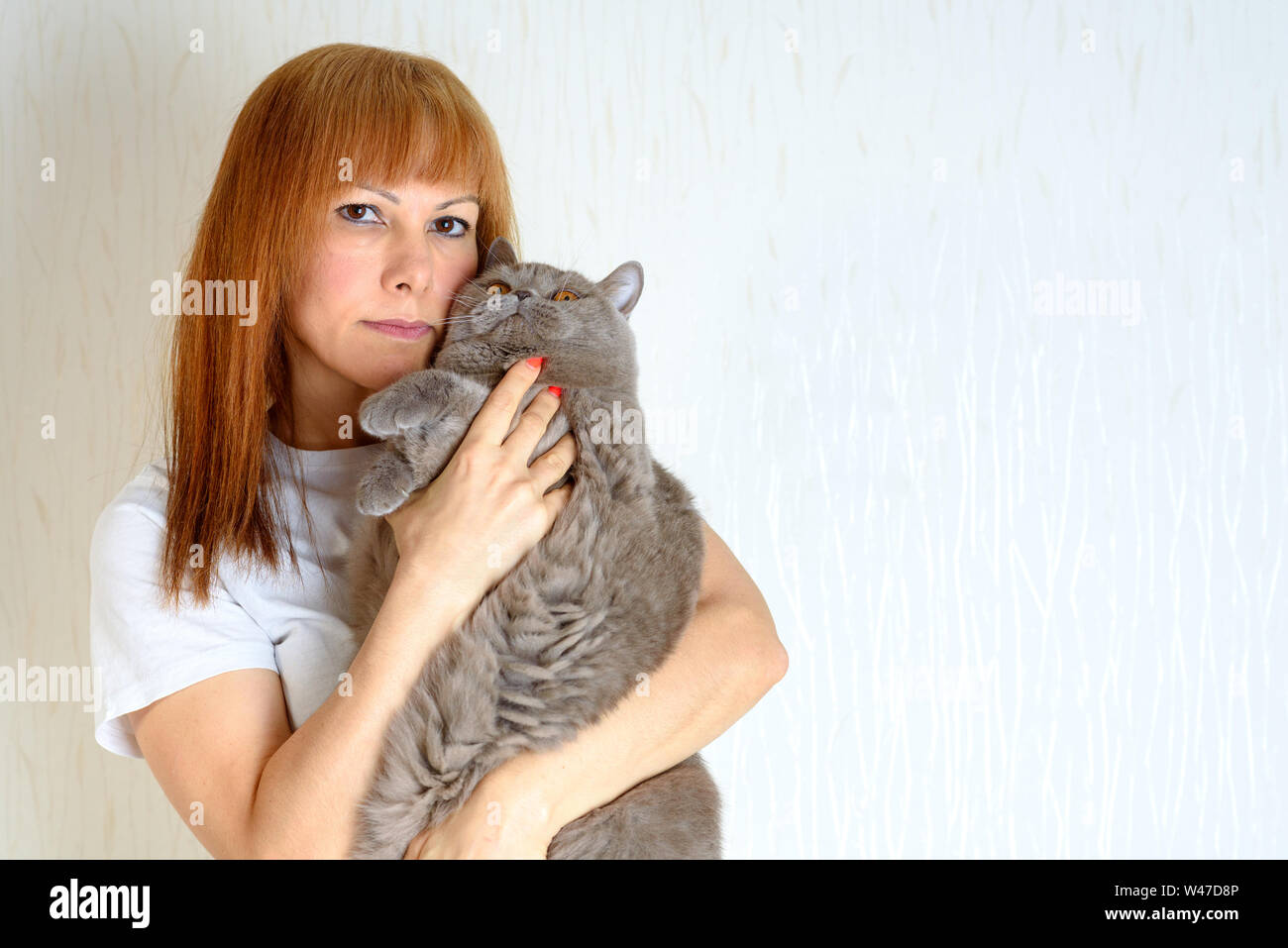 Blond Or Red Hair Mature Senior Female Relaxing At Home Holding