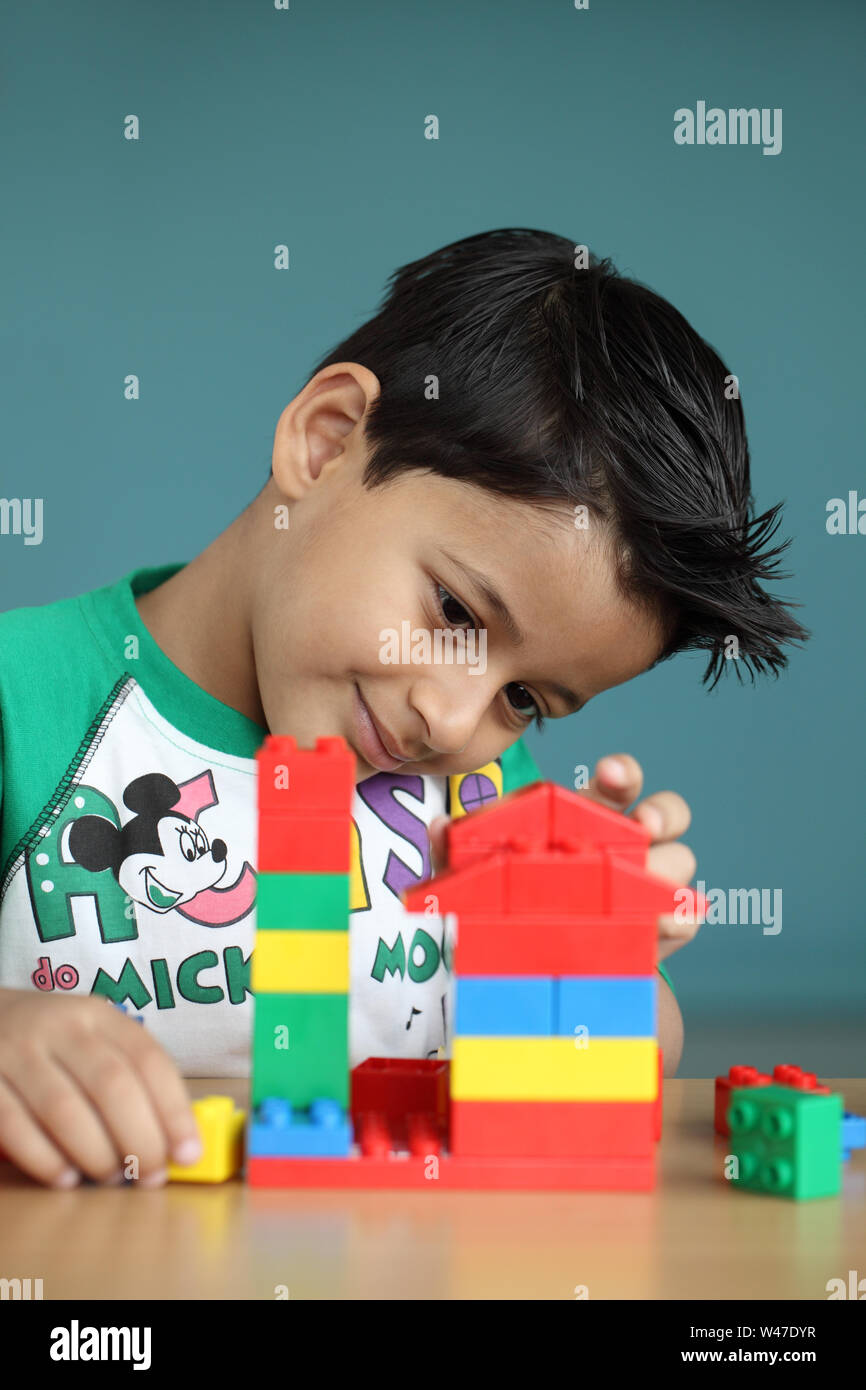 Boy playing with blocks Stock Photo - Alamy