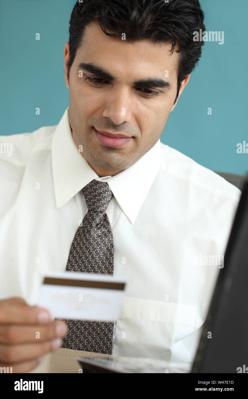 Indian businessman shopping online with a credit card Stock Photo Alamy