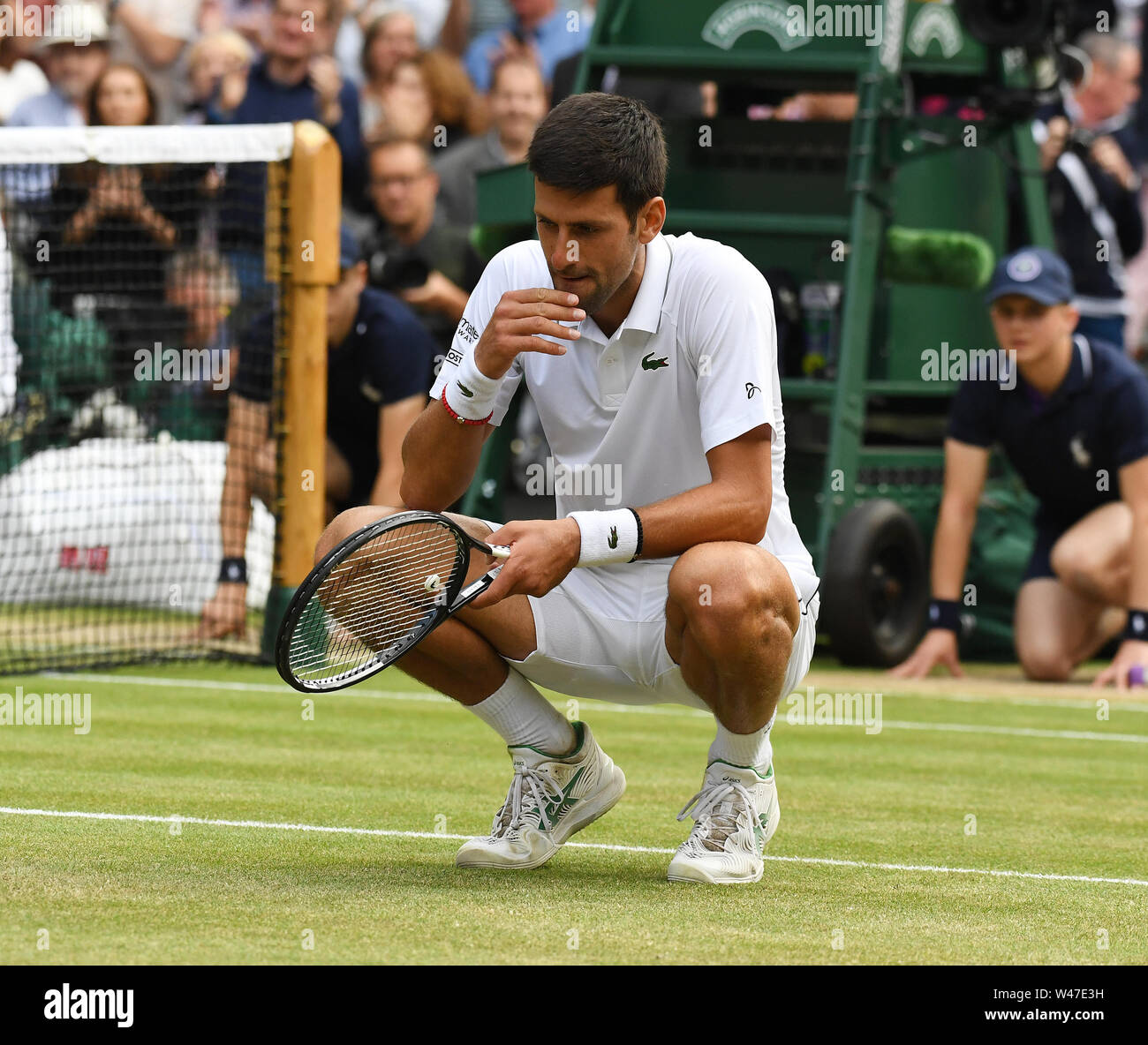 London England  14 July 2019 The Championships Wimbledon 2019 14072019 Novak Djokovic (SRB) tastes the “Green,green grass of home”  after winning Mens Stock Photo