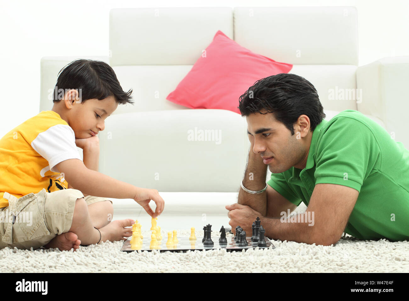 Man with his son playing chess at home Stock Photo