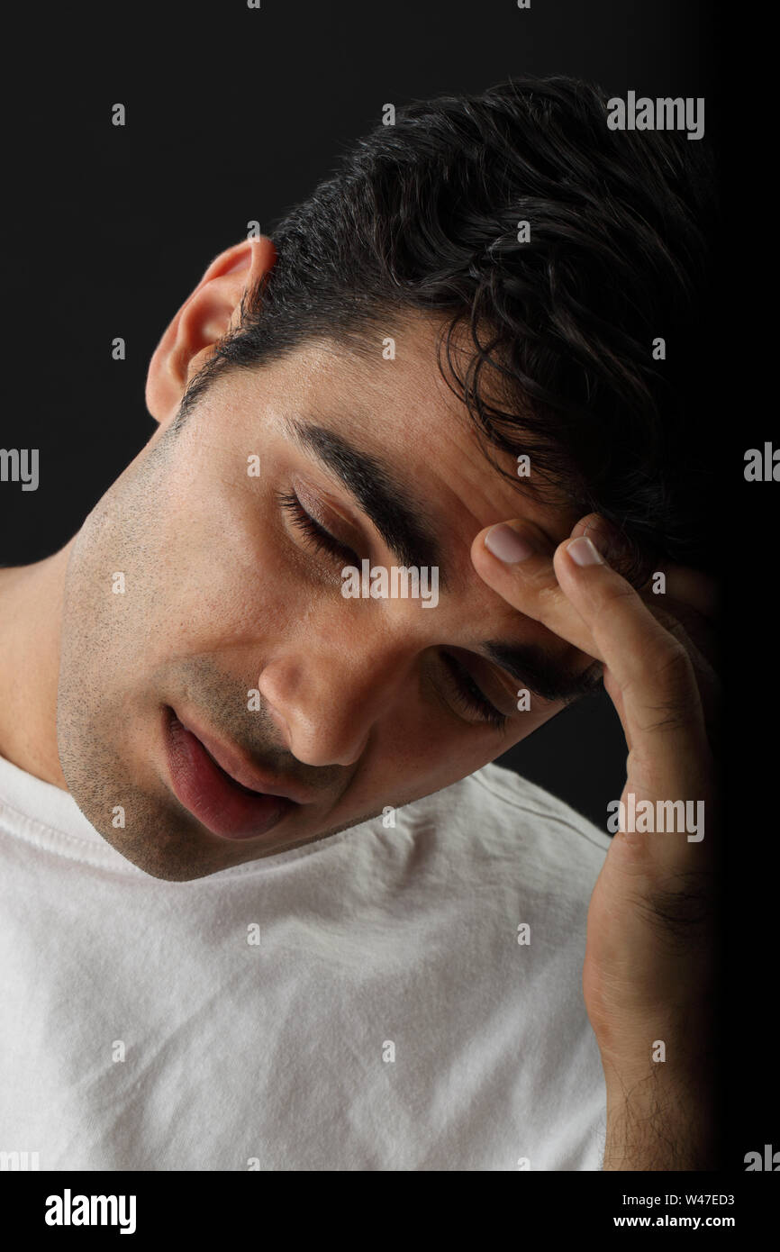 Indian young man suffering from headache Stock Photo - Alamy