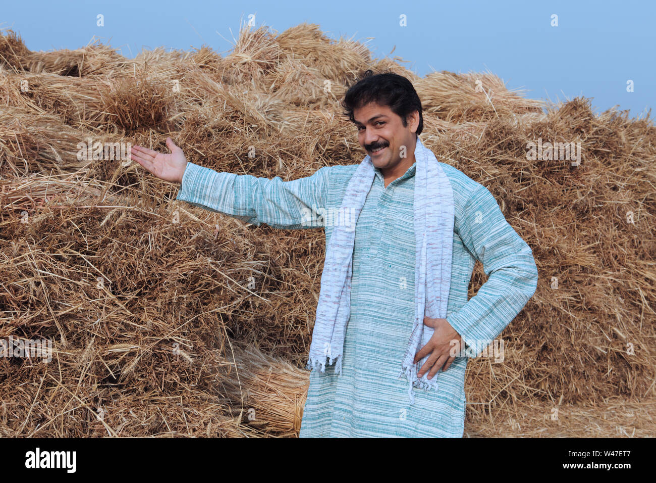 Farmer showing his harvested crop in a field Stock Photo - Alamy