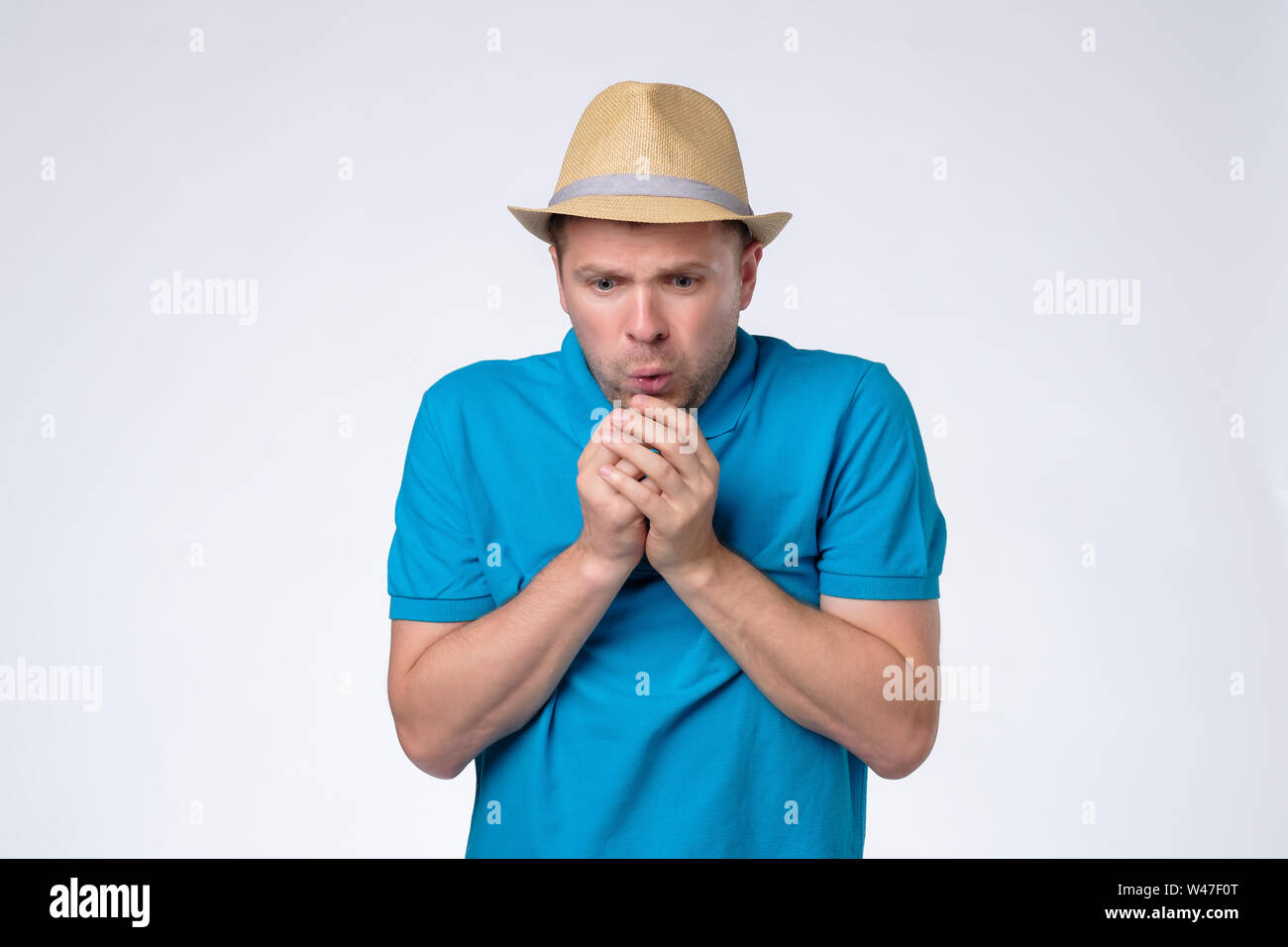 Handsome caucasian man freezing being cold and ill. Stock Photo