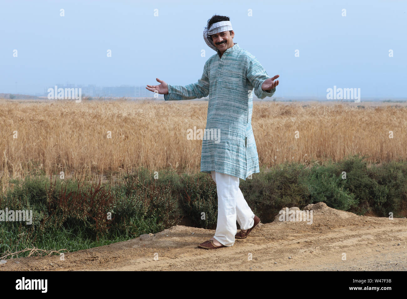 Farmer showing his field and walking Stock Photo - Alamy
