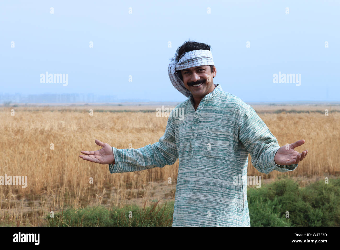 Farmer showing his field Stock Photo - Alamy
