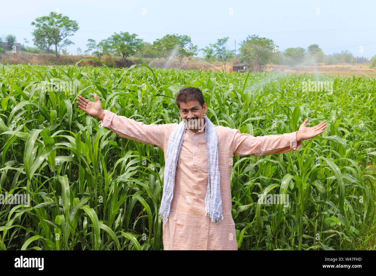 Farmer showing his maize field Stock Photo - Alamy