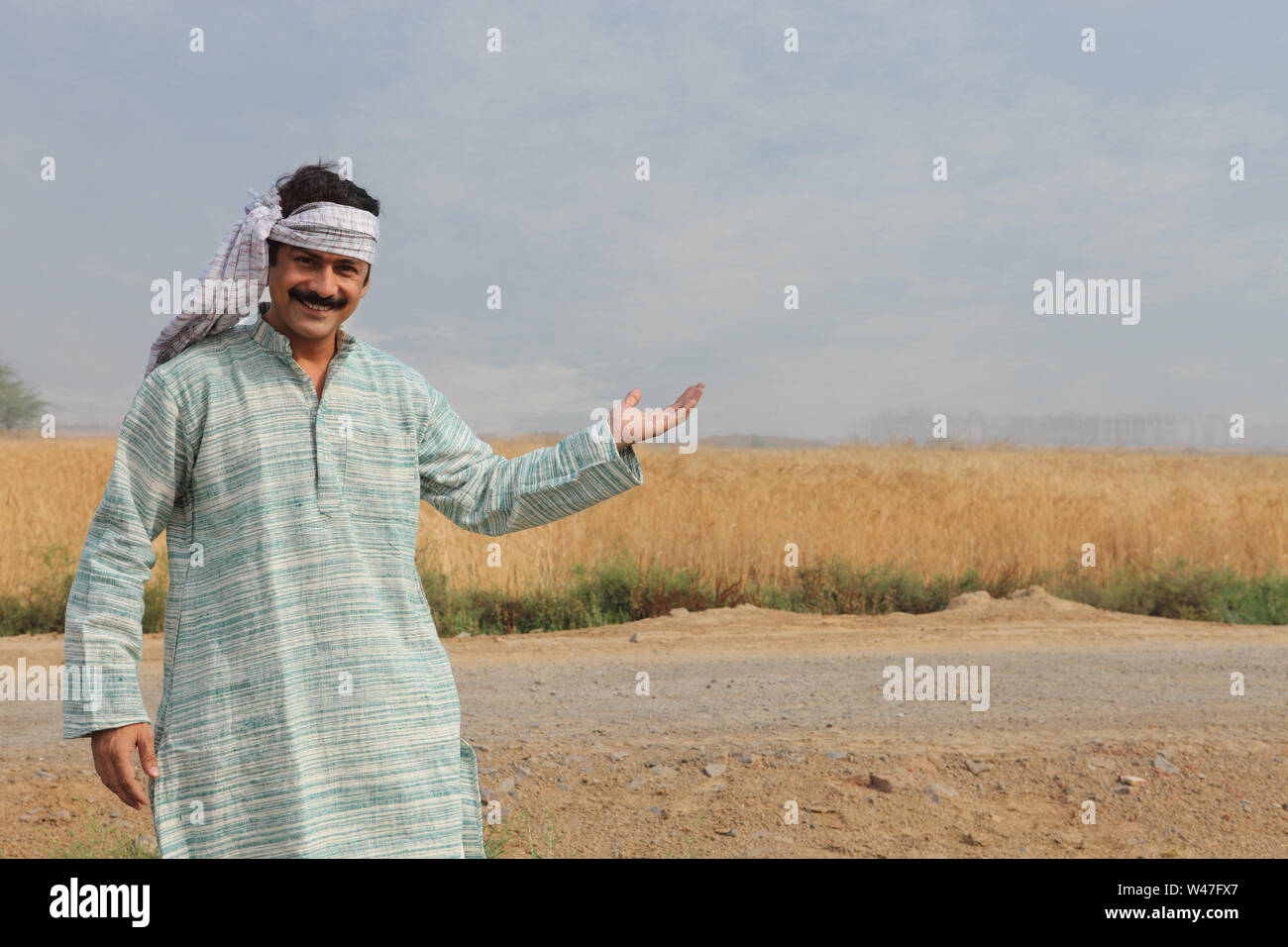Farmer showing his field Stock Photo - Alamy
