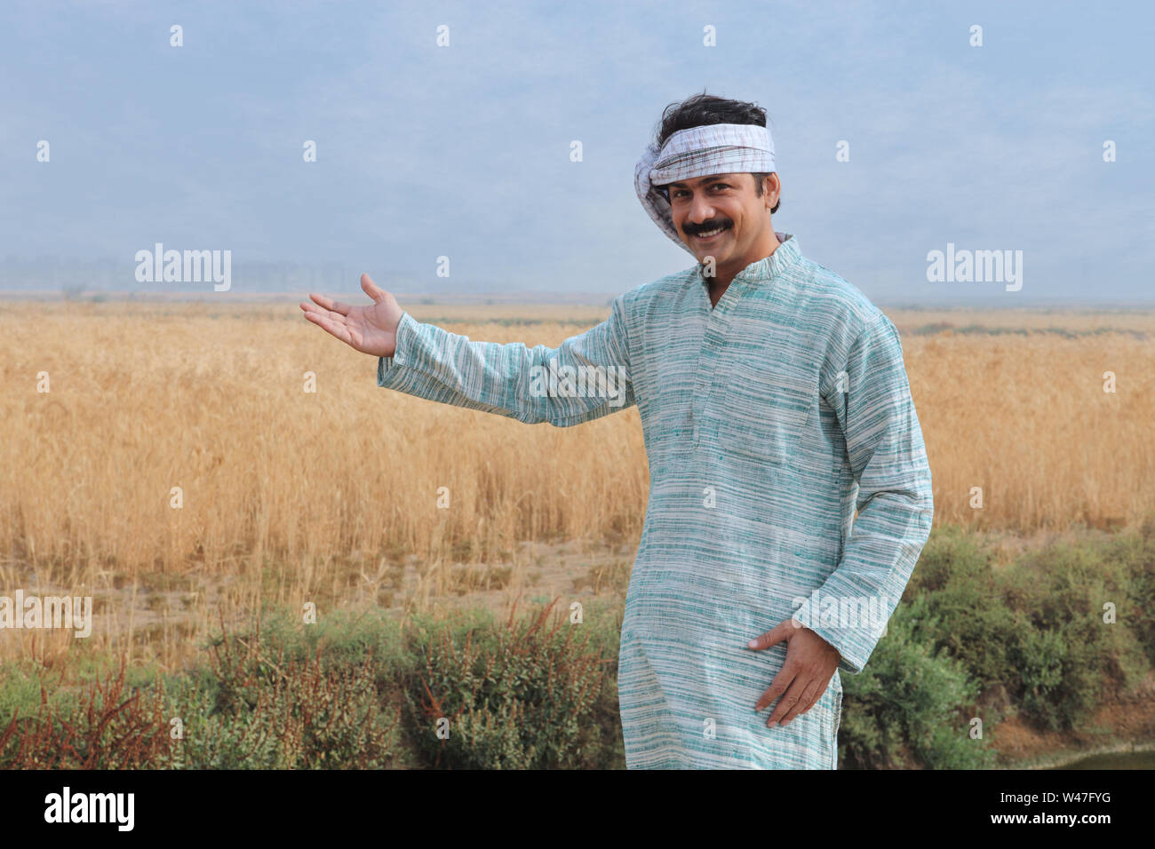 Farmer showing his field Stock Photo - Alamy