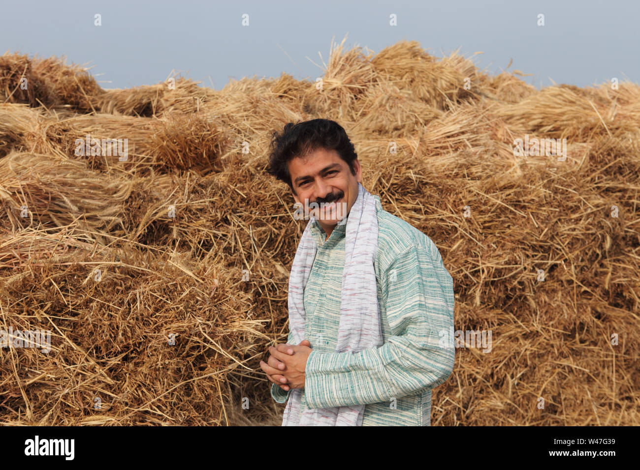 Indian farmer standing in harvested crop field Stock Photo - Alamy