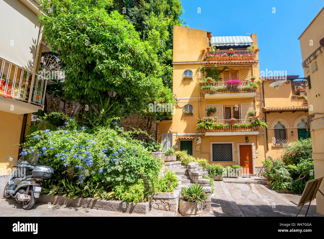 Street photo with colorful facades of houses in resort town Taormina. Sicily, Italy Stock Photo