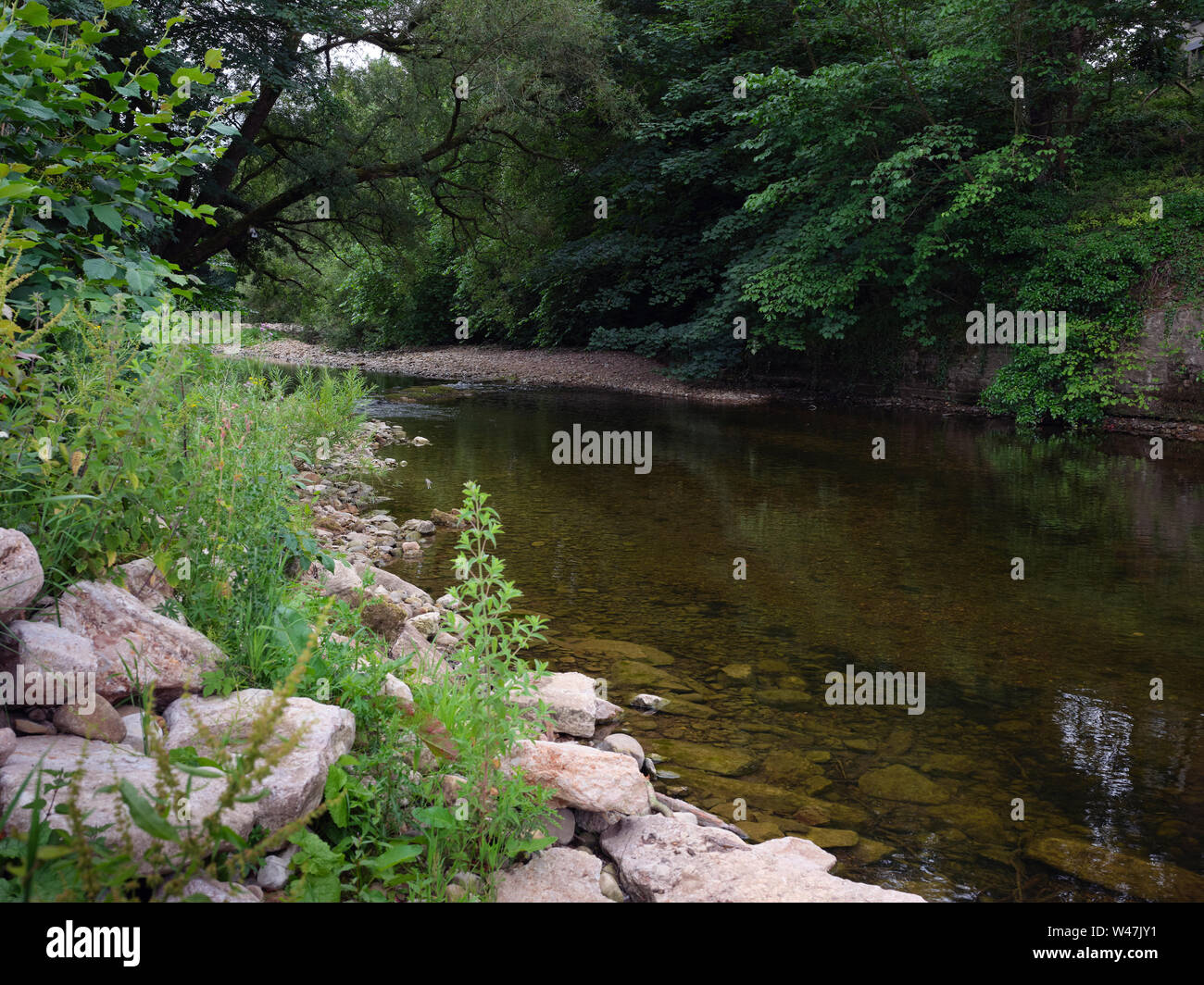 At Hartley by Kirkby Stephen in Cumbria, looking downstream from the stone Bridge over river Eden Stock Photo