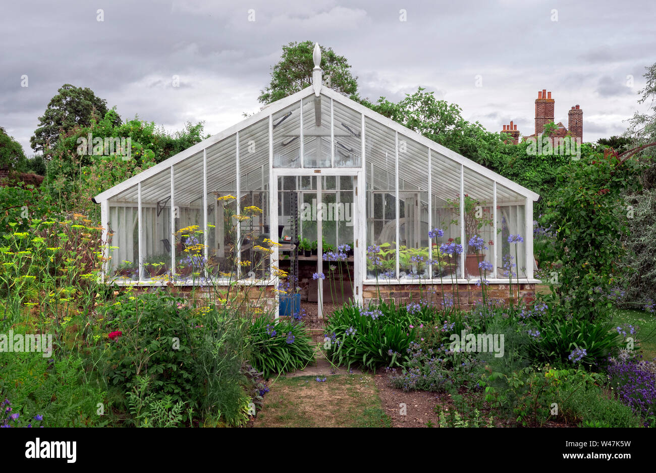 Wooden greenhouse in English country house garden Kent UK Stock Photo