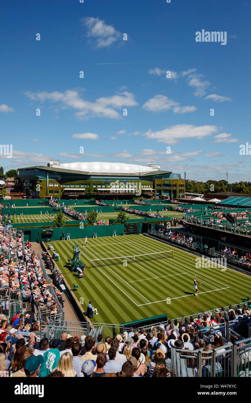 Caty McNally and Heather Watson on court 12 with a General View of Centre Court and The Wimbledon Championships 2019. Held at The All England Lawn Ten Stock Photo