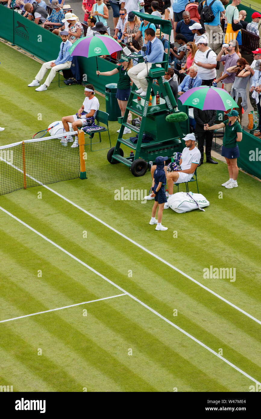 General Aerial View of players resting under umbrellas at The Wimbledon Championships 2019. Held at The All England Lawn Tennis Club, Wimbledon. Stock Photo