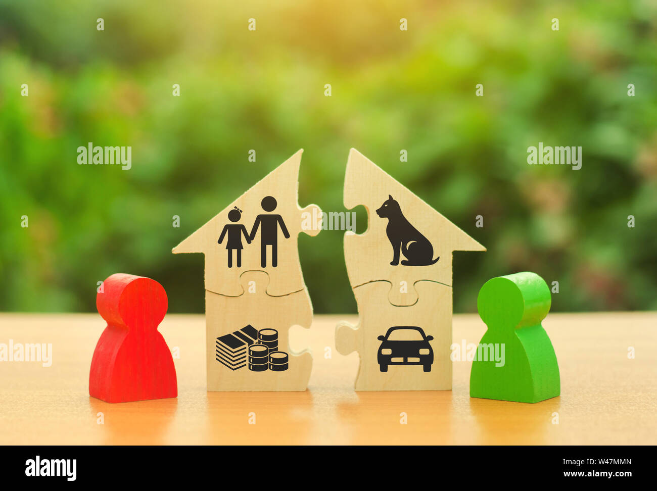 Two human figures divide the house among themselves. Divorce concept