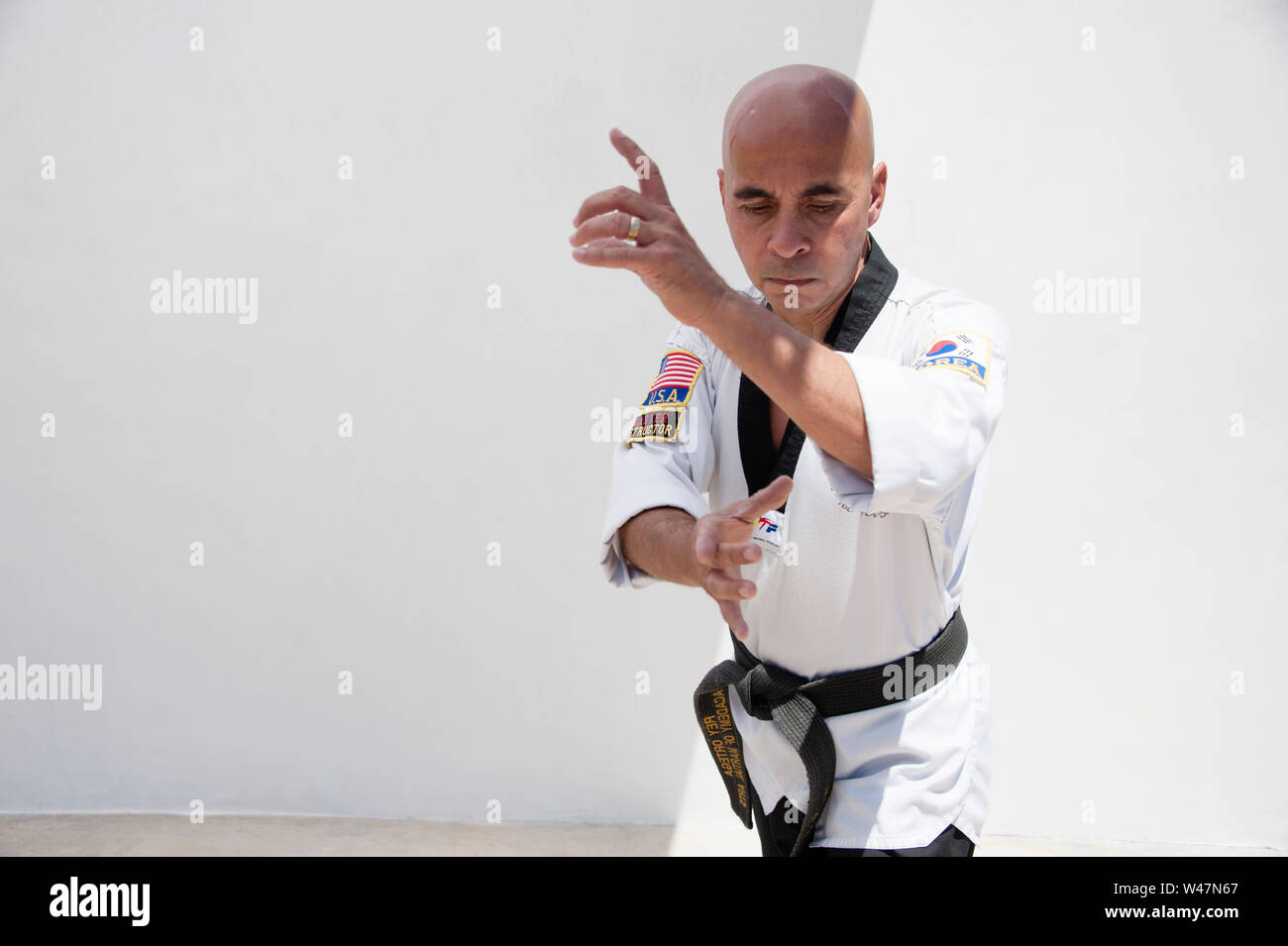 Black belt Sensei martial arts instructor demonstrating Taekwondo form