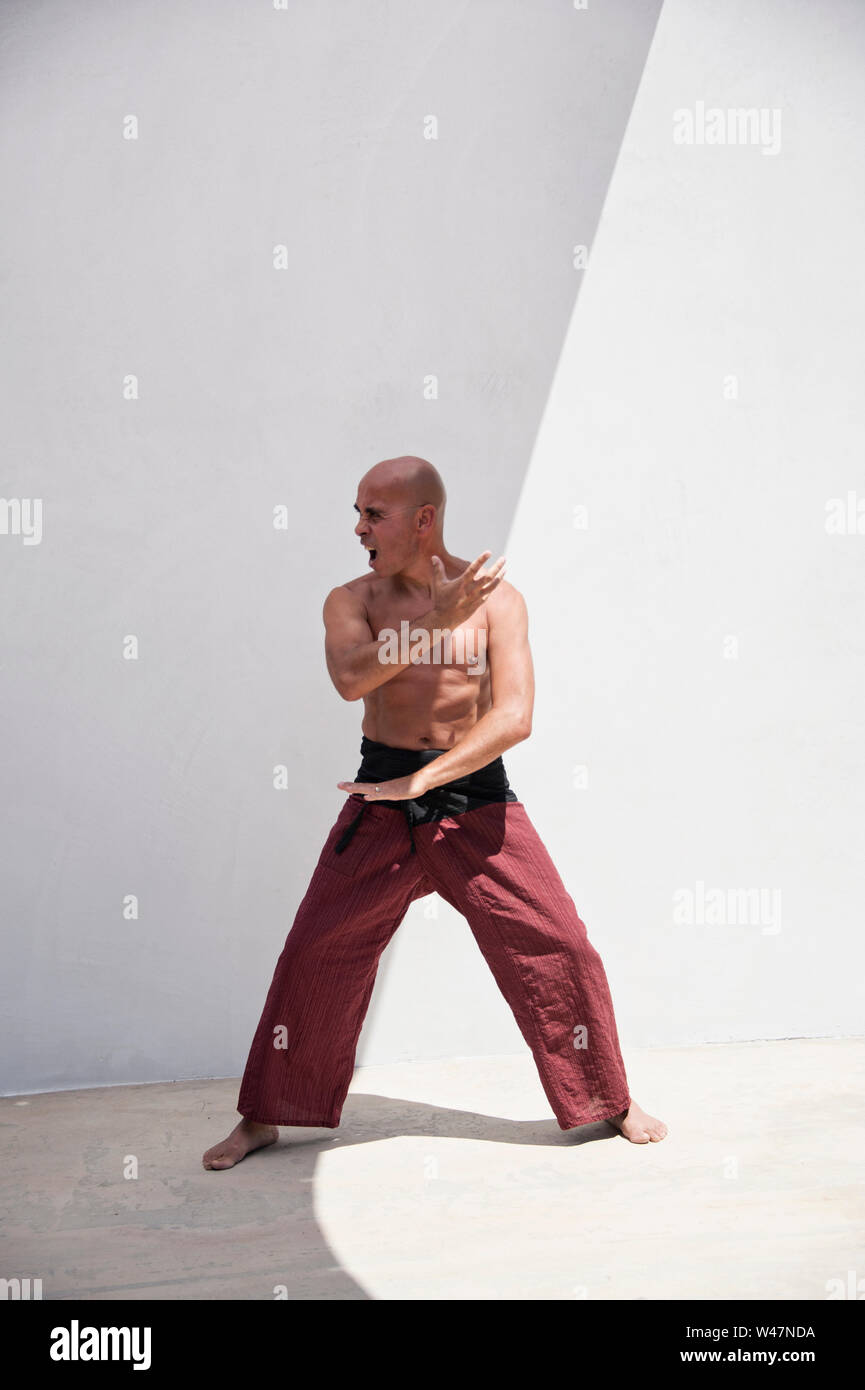 Martial Arts man practicing mindfulness exercises to harmonize body
