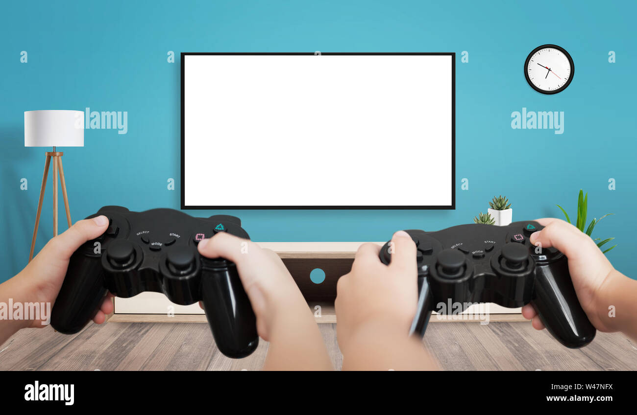 man with a controller standing in front of a PC console TV screen with a  steam controller playing popular free to play game Roblox Stock Photo -  Alamy