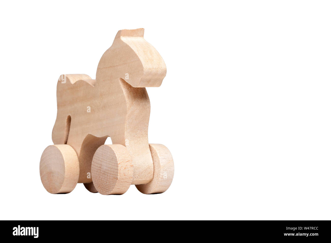 Minimalistic small wooden horse figure design on wheels, concept of trojan horse and mischief or simple child's toy isolated on white Stock Photo