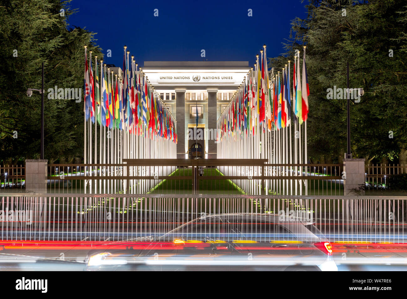 The United Nations member states flags in front of the United Nations Office in Geneva in the background. Palace of Nations, Geneva, Switzerland Stock Photo