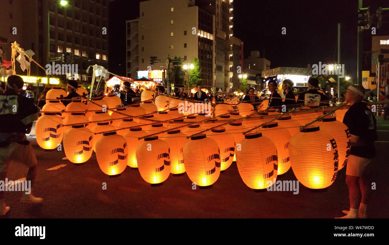 Akita Kanto Matsuri festival. a Japanese festival celebrated from 3–7 August, hope for good harvest. A long bamboo poles bearing lanterns are carried Stock Photo